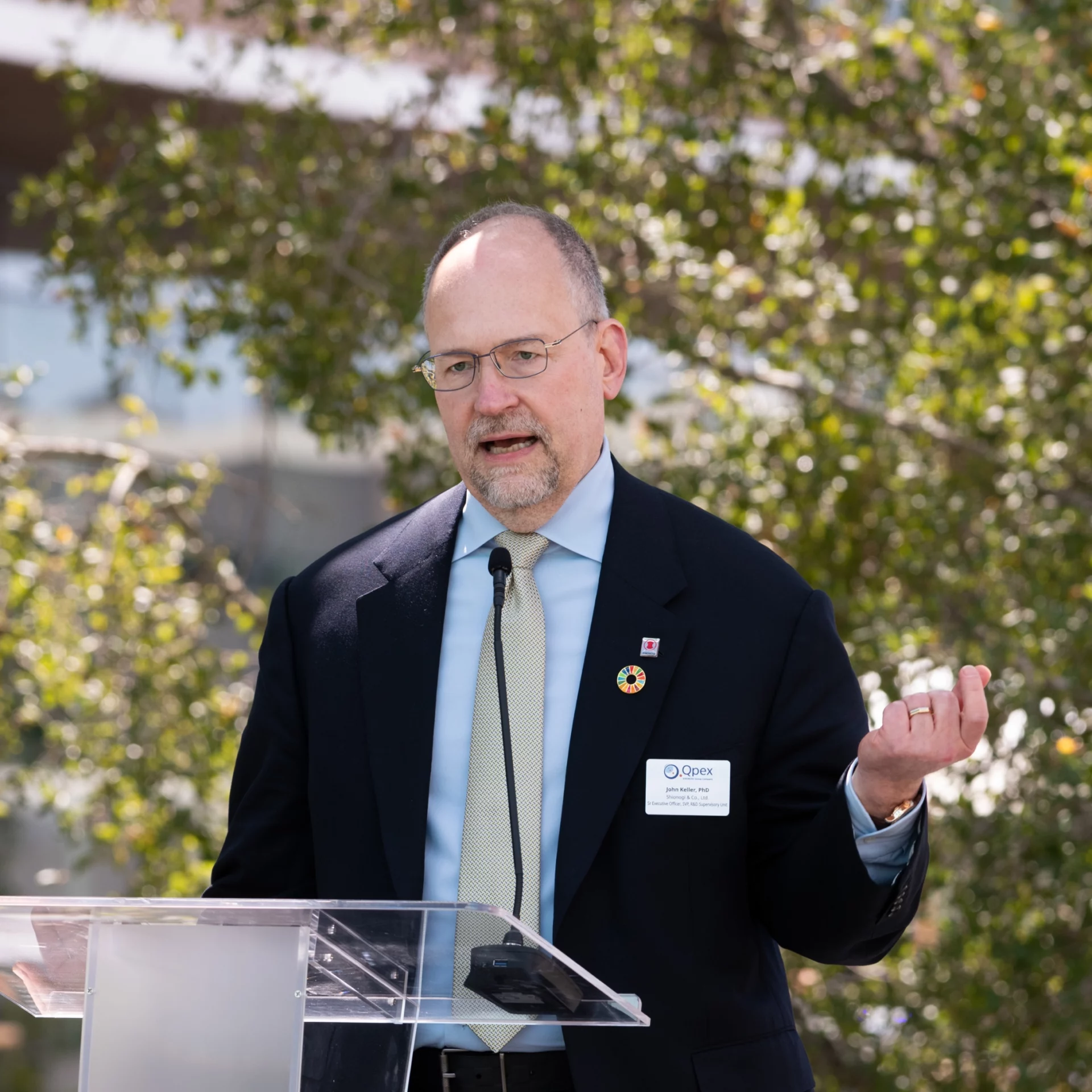 John Keller speaking at the podium.