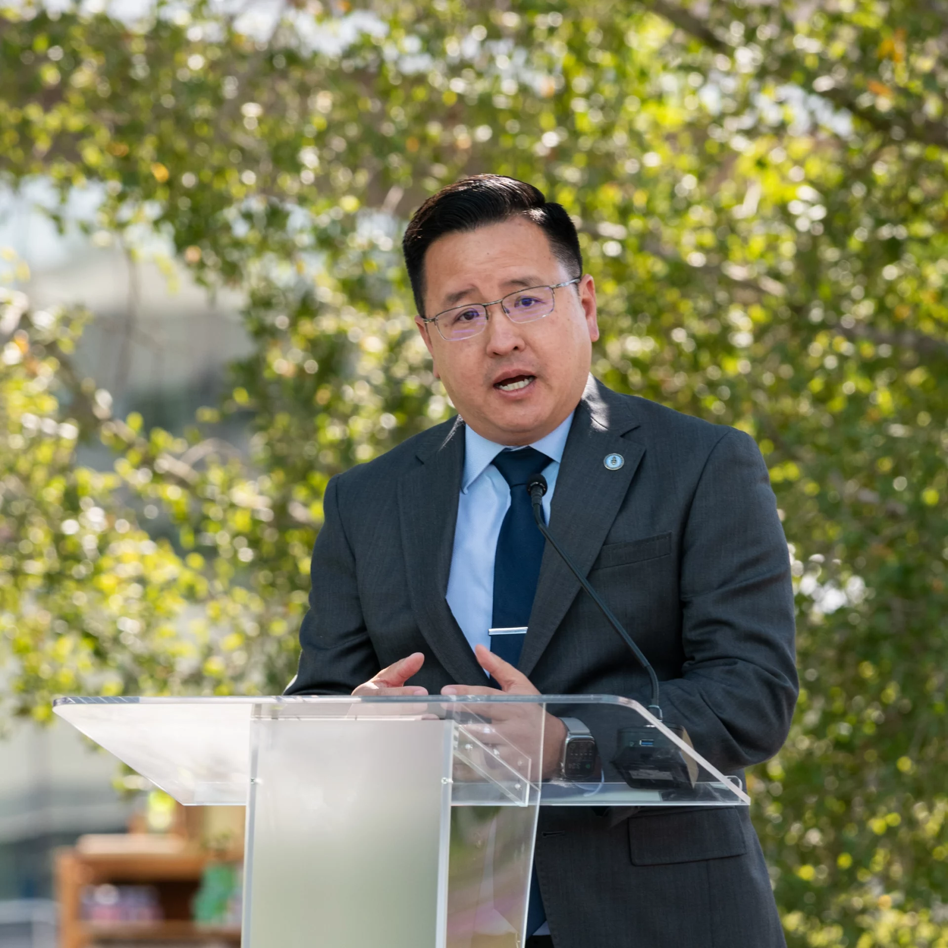 Kent Lee speaking at the podium.